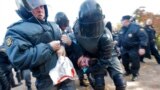 Riot police detain an anti-gay protester during an authorized gay rights rally in St. Petersburg, Russia.  A gay rights rally has ended in scuffles after several dozen protesters were confronted by about 200 conservative and religious activists. 