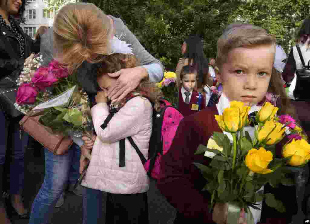 A girl in the first grade cries during a ceremony marking the start of classes at a school as part of the traditional opening of the school year known as &quot;Day of Knowledge&quot; amid the ongoing COVID-19 pandemic in St. Petersburg, Russia.
