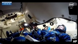 NASA astronauts Butch Wilmore, right and Suni Williams wait for liftoff inside the Boeing Starliner capsule at Space Launch Complex 41 Wednesday, June 5, 2024, in Cape Canaveral, Fla. (NASA via AP)