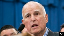 FILE - Gov. Jerry Brown speaks at a Capitol news conference in Sacramento, Calif., July 17, 2017. On Oct. 5, 2017, Brown signed sanctuary state legislation extending protections for immigrants living in the United States illegally. 