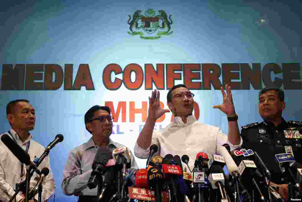 Malaysia's acting Transport Minister Hishammuddin Hussein (2nd right) speaks about flight MH370 at Kuala Lumpur International Airport, March 16, 2014.