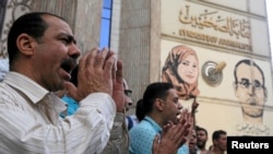 FILE - Journalists and activists protest against the restriction of press freedom and to demand the release of detained journalists, in front of the Press Syndicate in Cairo, Egypt, April 26, 2016.