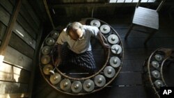 Mao Phoeung, a Cambodian music master, plays traditional circular gongs at his home in Phnom Penh, file photo. Mao Phoeung's teachings are funded by the Cambodian Living Arts program, part of an effort by the Cambodian-American group to breath new life in