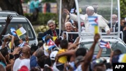 Pope Francis waves from the popemobile upon his arrival at El Cobre, Santiago de Cuba, to give a prayer at a basilica to Our Lady of Charity of El Cobre, the patron saint of Cuba, Sept. 21, 2015. 
