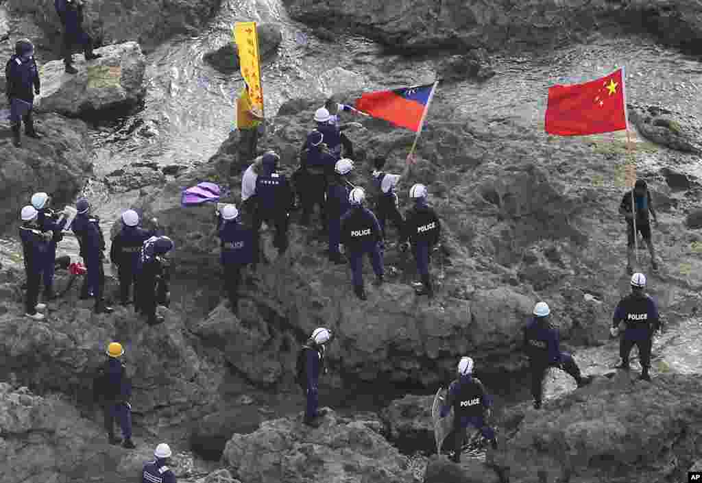 August 15: Activists holding Chinese and Taiwanese flags are arrested by Japanese police officers after landing on Uotsuri Island, one of the islands claimed by both China and Japan.
