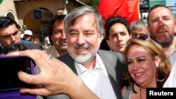 FILE - Center-left Chilean senator and presidential candidate Alejandro Guillier takes part in a campaign rally ahead of the next presidential election in November 2017, in Villa Alemana, Valparaiso, Chile, Oct. 10, 2017.