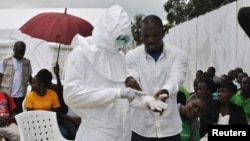 A volunteer health worker practices using a personal protective equipment (PPE) suit at a newly-constructed Ebola virus treatment centre in Monrovia, Liberia, Sept. 21, 2014.
