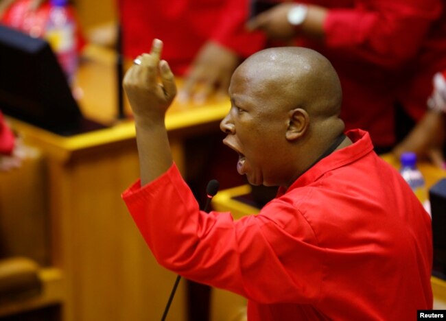 FILE - Julius Malema, leader of the Economic Freedom Fighters (EFF) party, raises objections before being evicted from Parliament during President Jacob Zuma's question and answer session in Cape Town, South Africa, May 17, 2016.