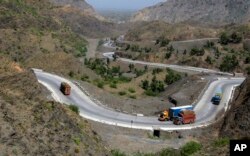 Afghanistan-bound trucks pass through a valley while moving toward the Torkham border crossing in Torkham, Pakistan, June 18, 2016.