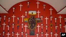FILE - Crosses representing 72 migrants massacred in 2010 adorn the chapel at La 72, a migrant shelter in Tenosique, Tabasco state, Mexico, Dec. 6, 2016.