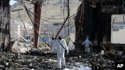 Forensic experts investigate the scene at the community hall where Saudi-led warplanes struck a funeral in Sanaa, the capital of Yemen, Oct. 9, 2016. 