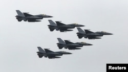 FILE - Taiwan Air Force's F-16 fighter jets fly during the annual Han Kuang military exercise at an army base in Hsinchu, northern Taiwan, July 4, 2015. 