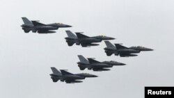 FILE - Taiwan Air Force's F-16 fighter jets fly during the annual Han Kuang military exercise at an army base in Hsinchu, northern Taiwan, July 4, 2015. 