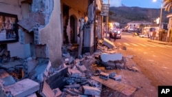 Debris of a partially collapsed house sit on the street in Fleri, Sicily, Dec. 26, 2018. 