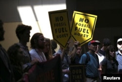 FILE - Demonstrators with the group Sunrise Movement gather after interrupting a resolutions meeting at the Democratic National Committee (DNC) Summer Meeting in Chicago, Illinois, Aug. 23, 2018.