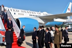 FILE - Brian Hook, director of policy planning for the State Department, steps off the bottom step with other State Department staff members upon their arrival to Pyongyang, North Korea, May 9, 2018.