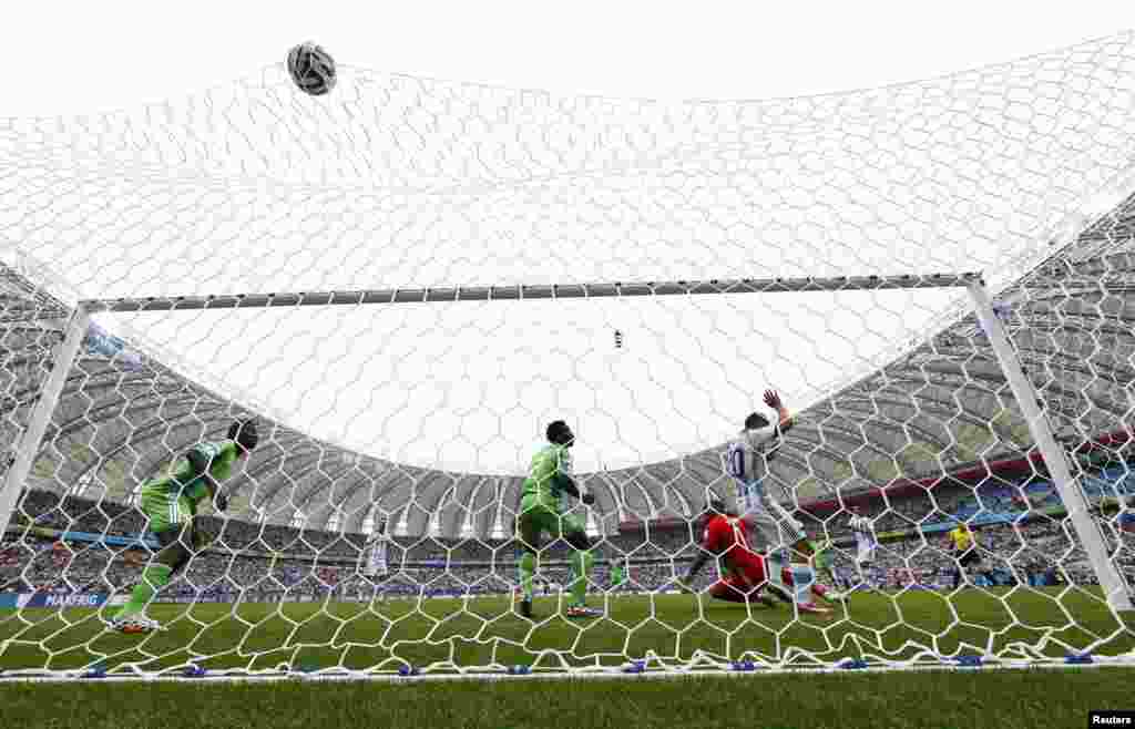 Argentinian Lionel Messi scores a goal against Nigeria at the Beira Rio stadium in Porto Alegre, June 25, 2014. 
