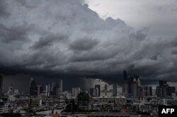 Heavy rain clouds move over the central business district in Bangkok.