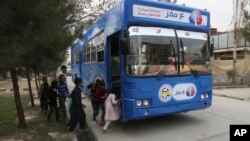 Afghan children board a library on wheels, in Kabul, Afghanistan, March 10, 2018.