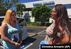 In this April, 28, 2015 photo, Adriana Garay, 29, right, talks with her niece, Haley Sandoval, 17, a student at the now-closed Everest College in Industry, California, hoping to get their transcripts and information on loan forgiveness.