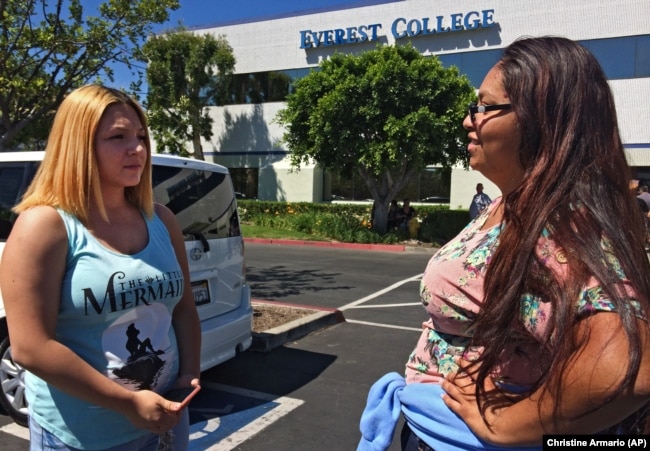 In this April, 28, 2015 photo, Adriana Garay, 29, right, talks with her niece, Haley Sandoval, 17, a student at the now-closed Everest College in Industry, California, hoping to get their transcripts and information on loan forgiveness.