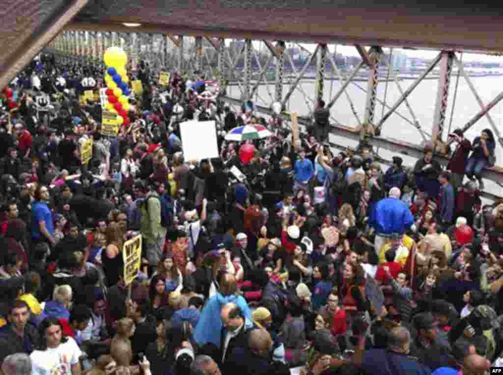 A large group of protesters affiliated with the Occupy Wall Street movement attempt to cross the Brooklyn Bridge, effectively shutting parts of it down, Saturday, Oct. 1, 2011 in New York. Police arrested dozens while trying to clear the road and reopen f