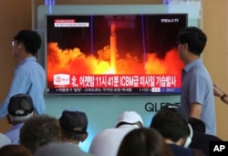 People watch a TV news program showing an image of North Korea's latest test launch of an intercontinental ballistic missile at the Seoul Railway Station in Seoul, South Korea, July 29, 2017.