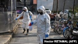 Health emergency crew disinfect an area in Wuhan, China during the coronavirus outbreak