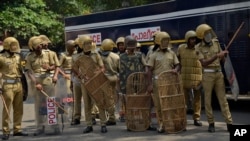 Policemen take position outside the state secretariat anticipating protests following reports of two women of menstruating age entering the Sabarimala temple, one of the world's largest Hindu pilgrimage sites, in Kerala state, India.