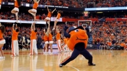 Syracuse University mascot “Otto the Orange” cheers with members of the Syracuse University cheerleading team before an NCAA college basketball game against Pittsburgh in Syracuse, N.Y., Saturday, Feb. 20, 2016. (AP Photo/Nick Lisi)