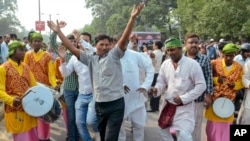 Supporters of an alliance of parties opposed to India’s ruling Bharatiya Janata Party celebrate victory in Bihar state elections Nov. 8, 2015. (AP Photo/Aftab Alam Siddiqui)