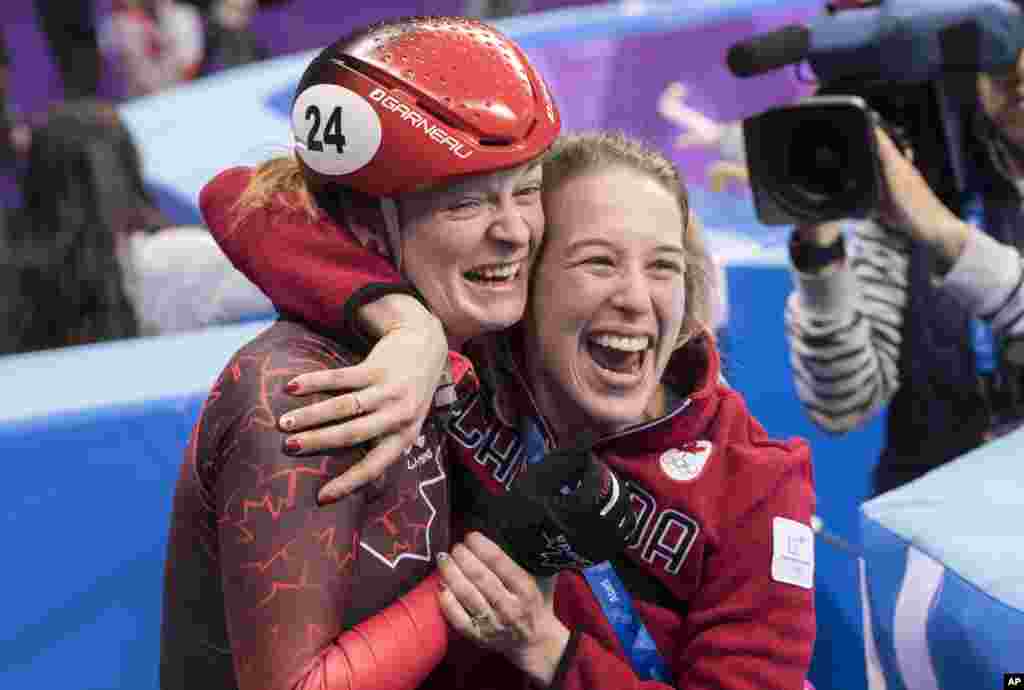 Canada's Kim Boutin is hugged by teammate Marianne St-Gelias after finding out she has won the bronze medal in the women's 500-meter short-track speedskating final at the Pyeonchang Winter Olympics, Feb. 13, 2018 in Gangneung, South Korea.