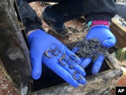 Jennifer Christensen sorts through items found in a safe at the remains of her home Dec. 5, 2018, in Paradise, California.