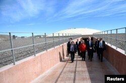 Chile's President Michelle Bachelet and Director General of the European Southern Observatory, Tim de Zeeuw walk at the construction site of the world's largest telescope in the desert of Atacama, Chile, May 26, 2017.