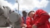 South Sudan's Minister for Petroleum and Mining Stephen Dhieu Dau (L) prepares to press a button to resume oil production in May, 15 months after production was shutdown. South Sudan is struggling to repay loans it took out during the shutdown.