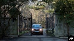 FILE - A car with diplomatic license plates drives out of a compound near Glen Cove, N.Y., on Long Island, Dec. 30, 2016. 