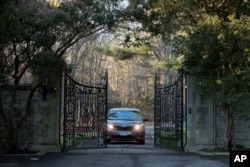 FILE - A car with diplomatic license plates is seen leaving a compound near Glen Cove, New York, Dec. 30, 2016. The compound is one of the estates whose return Russia is demanding. The other is located in Centreville, Maryland, some 90 km outside of Washington, D.C.