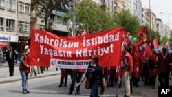 Protesters hold banners during a May Day protest in Ankara, Turkey, May 1, 2017. Workers and activists marked May Day with defiant rallies and marches for better pay and working conditions Monday. 