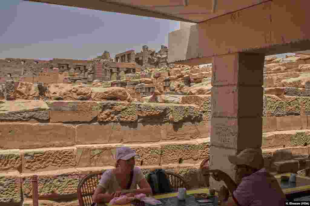 Western tourists take a rest from the midday sun in a cafeteria inside Karnak temple in Luxor, Egypt, April 20, 2018.&nbsp;