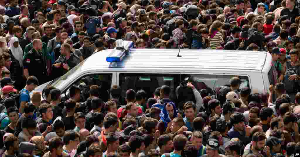 Migrants queue up for buses after they arrived at the border between Austria and Hungary near Heiligenkreuz, about 180 kms (110 miles) south of Vienna. Thousands of migrants who had been stuck for days in southeastern Europe started arriving in Austria early Saturday after Hungary escorted them to the border.