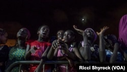 Local youth watch models on the catwalk at Dakar Fashion Week's "Street Show," in the Niary Tally neighborhood, June 29, 2017.