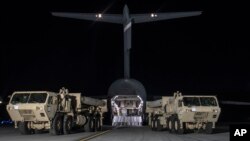 In this photo provided by U.S. Forces Korea, trucks carrying U.S. missile launchers and other equipment needed to set up the Terminal High Altitude Area Defense (THAAD) missile defense system arrive at the Osan air base in Pyeongtaek, South Korea, March 6, 2017.