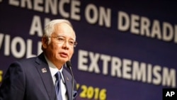 In this Jan. 25, 2016 photo, Malaysian Prime Minister Najib Razak speaks at a conference in Kuala Lumpur, Malaysia. 