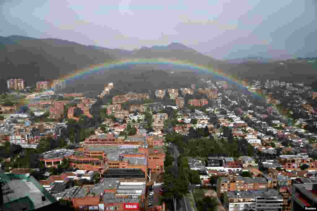 A rainbow appears over the eastern hills in Bogota, Colombia, Aug. 9, 2018.