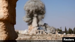 FILE - An image distributed by Islamic State militants on social media on August 25, 2015 purports to show the destruction of a Roman-era temple in the ancient Syrian city of Palmyra. 