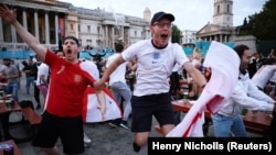 Soccer Football - Euro 2020 - Fans gather in London ahead of Ukraine v England - London, Britain - July 3, 2021 England fans celebrates scoring a goal in Trafalgar Square during the match
