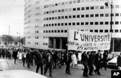 FILE - Paris students march on June 9, 1968, around the French Maison de la Radio in support of the striking TV and radio employees. The banner reads The University for the Liberty of News and the Autonomy of the ORTF (the Government controlled TV and radio system). Daily marches have been organized around the Radio House during the strike.