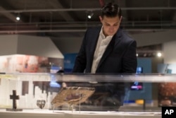 A visitor to a preview of the 9/11 Tribute Museum in New York looks a display with artifacts from the World Trade Center site, June 8, 2017.