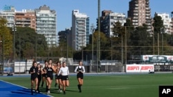 Las Leonas Argentina women's national field hockey team members run laps as they train for the Paris Olympic Games, in Buenos Aires, Argentina, Thursday, May 16, 2024.