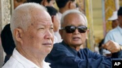 FILE - Former Khmer Rouge leaders Khieu Samphan, left, and Nuon Chea sit together during funeral services for Khieu Ponnary, the first wife of Khmer Rouge leader Pol Pot, in the former Khmer Rouge stronghold of Pailin, northwestern Cambodia, July 3, 2003.